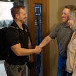 Three individuals shaking hands indoors, showcasing Cardinal Heating, Cooling, Plumbing & Electric's HVAC services.