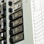 Control panel with switches and chart for tracking HVAC data by Cardinal Heating, Cooling, Plumbing & Electric.