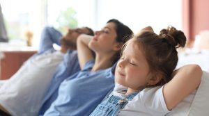 Family enjoying relaxation in comfortable seating, showcasing togetherness in a serene home environment.