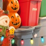 Colorful holiday scene with carved pumpkins and a snowman, featuring festive decorations and seasonal storage bins.