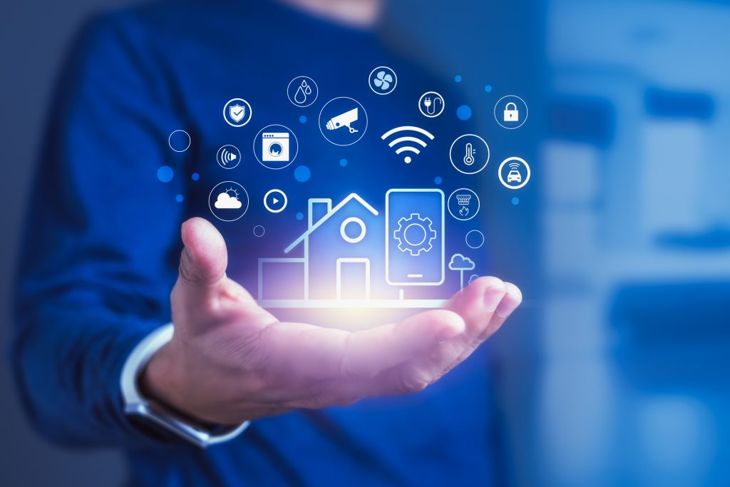 Human hand reaching towards smart home tech icons, showcasing innovative electrical services for modern residential needs.